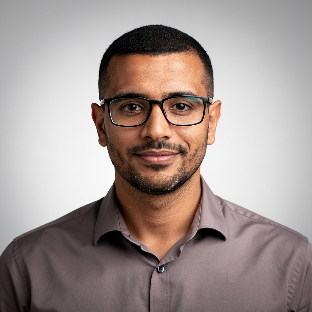 Portrait of a man with short black hair and glasses