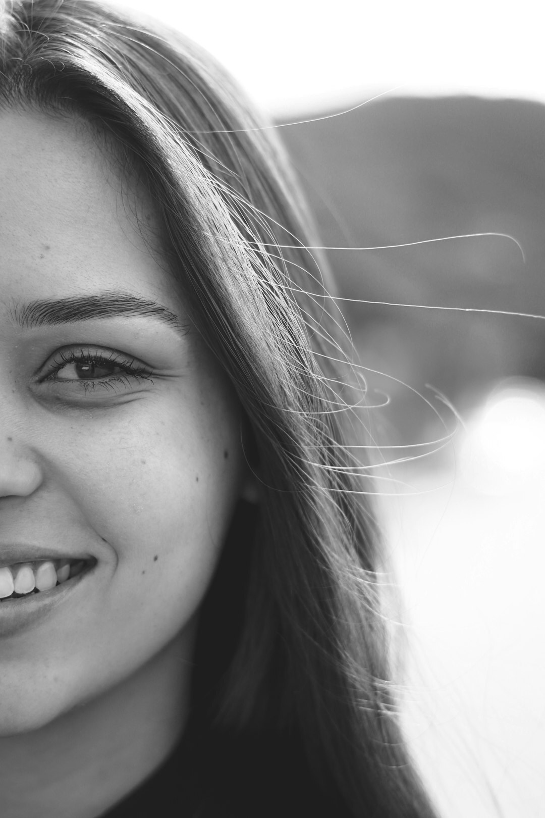 Portrait of a woman with long dark hair smiling